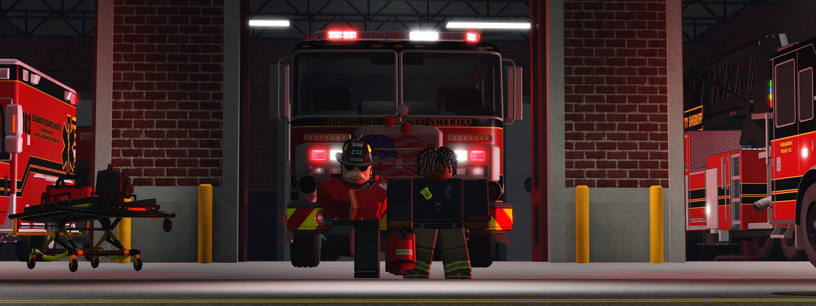 Two firefighters standing in front of a fire engine in the station bay