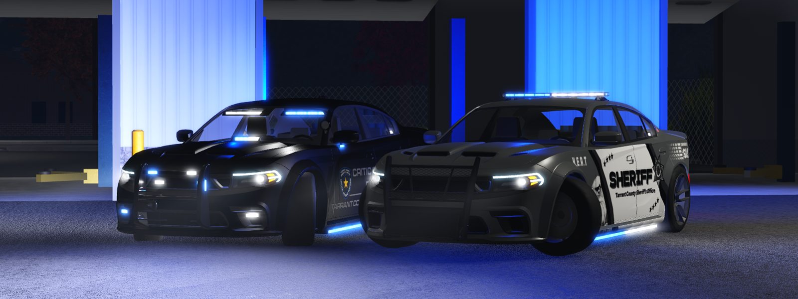 Two sheriff’s cars side by side at night, their blue lights on